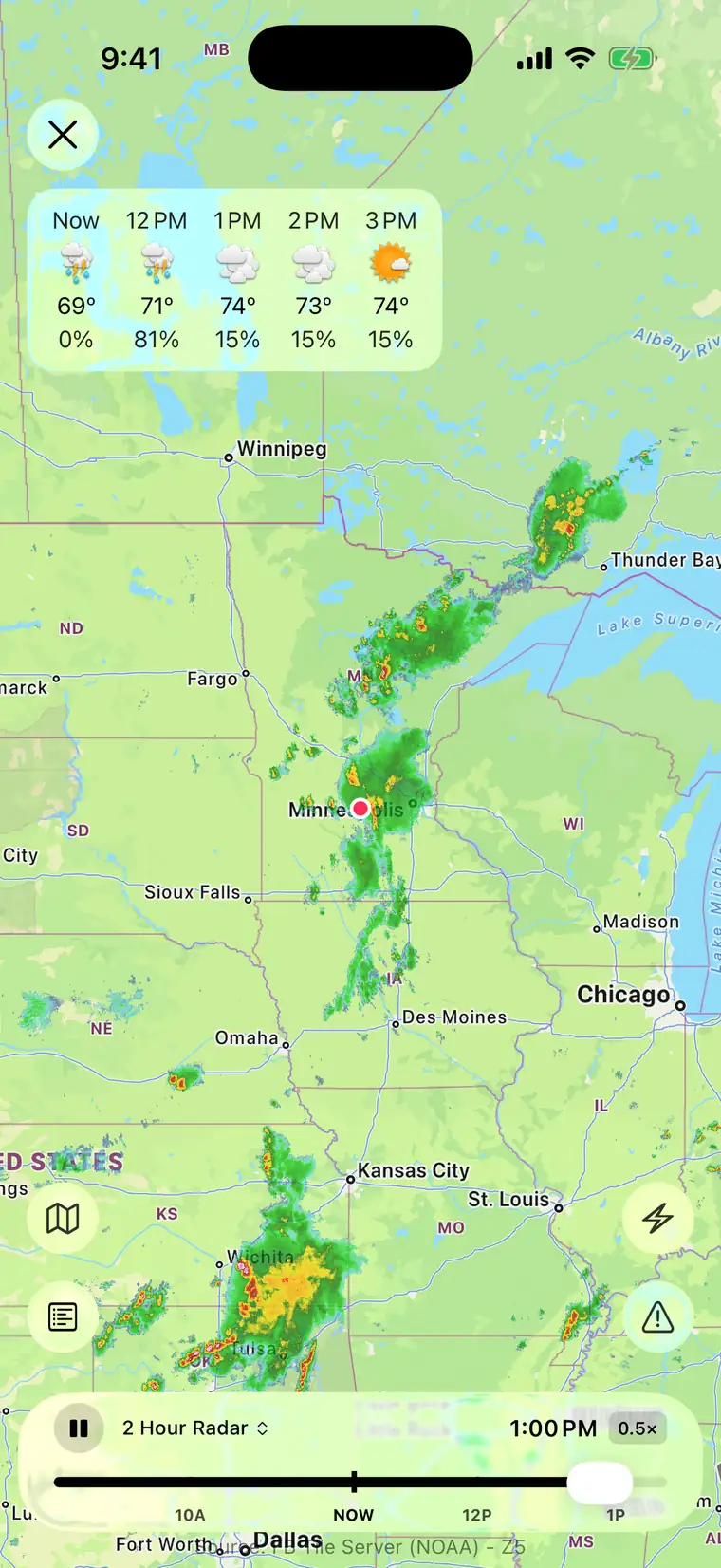 Radar playing on iPhone, a line of severe thunderstorms tracking across Minnesota in red and orange against the two-hour NOAA loop